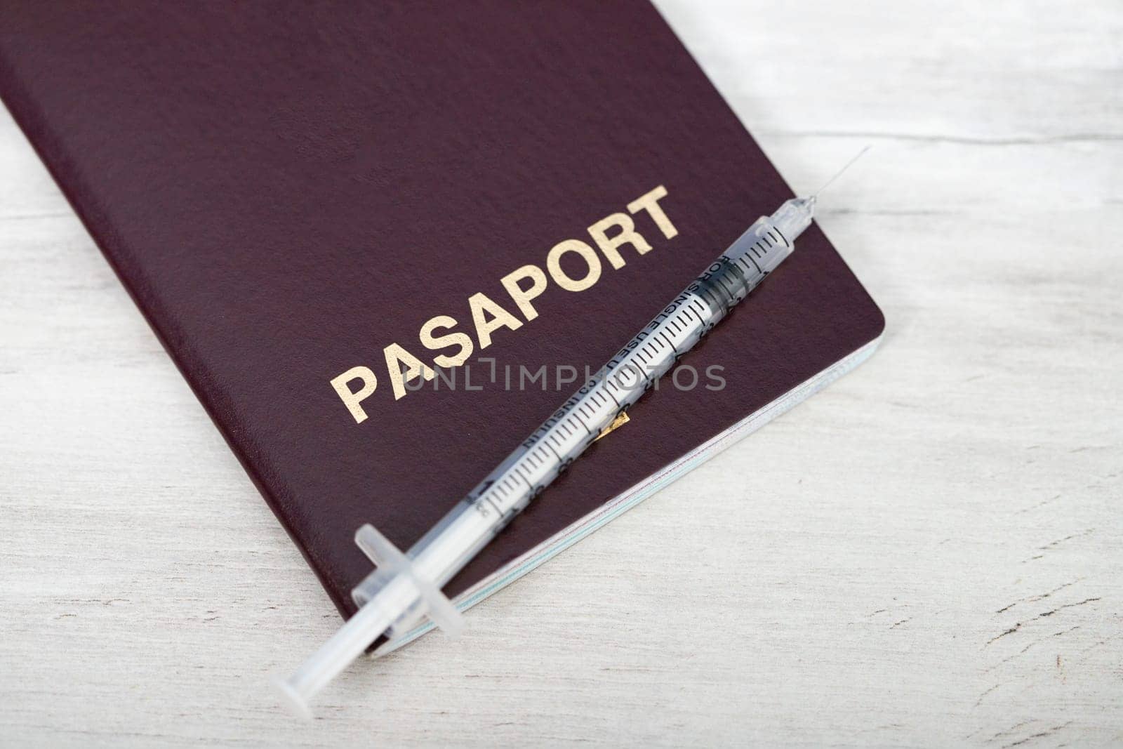 Travel restrictions concept for people without corona virus vaccination with syringe and travel passport
