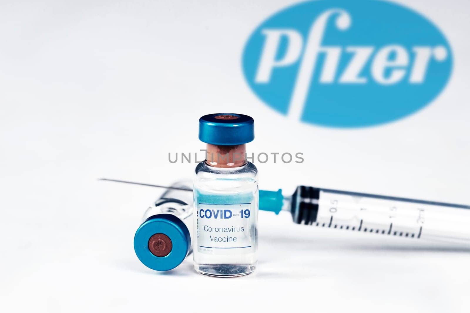 Cluj-Napoca, Romania - March 15, 2021:  New coronavirus vaccine Pfizer concept, blurred Pfizer logo on the background. Covid-19, 2019-nCov pandemic.
