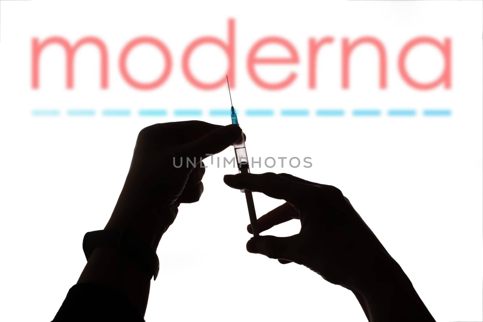 Cluj-Napoca, Romania - March 15, 2021:  New coronavirus vaccine Moderna concept, blurred Moderna logo on the background. Covid-19, 2019-nCov pandemic.