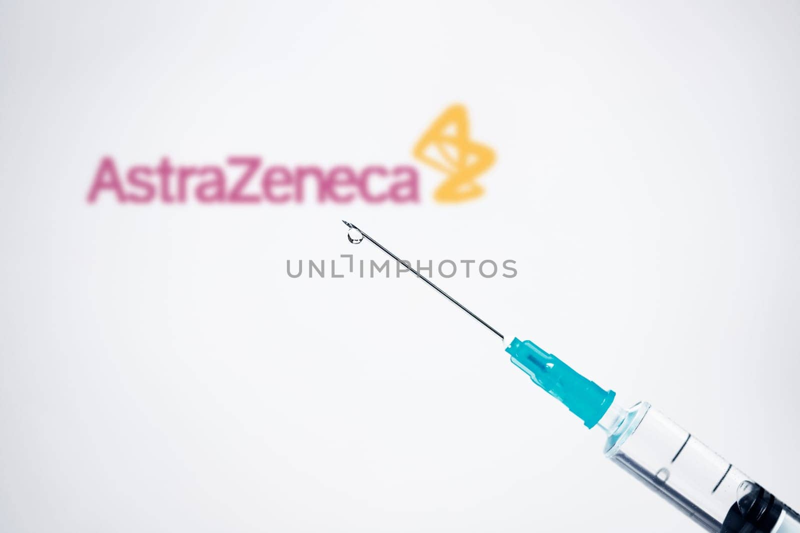 Cluj-Napoca, Romania - March 15, 2021:  New coronavirus vaccine Astra Zeneca concept, blurred Astra Zeneca logo on the background. Covid-19, 2019-nCov pandemic.
