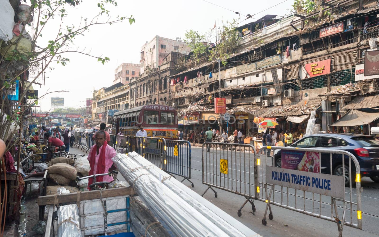 Crowded city street of Bara Bazar, a lively shopping district of Calcutta on a busy working day. Burrabazar, Kolkata West Bengal India South Asia Pacific March 22, 2021