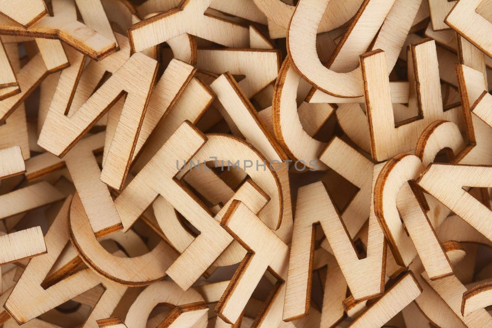 top view closeup detail macro of pile of wooden cut small alphabet letters