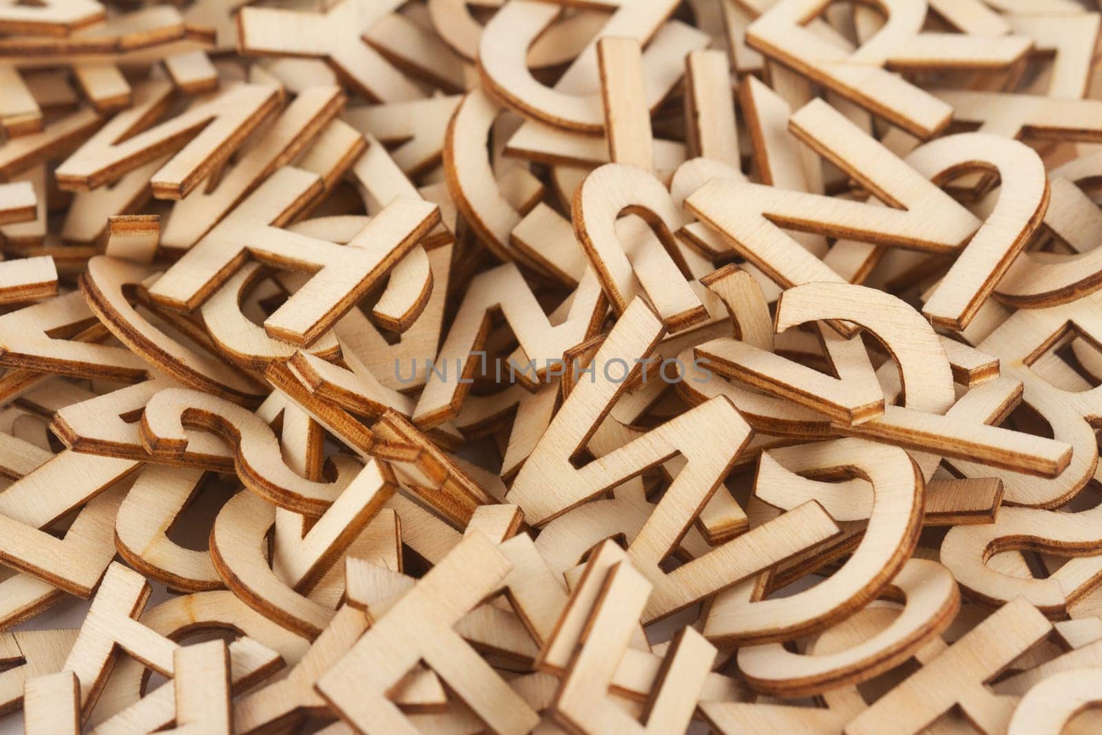 top view closeup detail macro of pile of wooden cut small alphabet letters