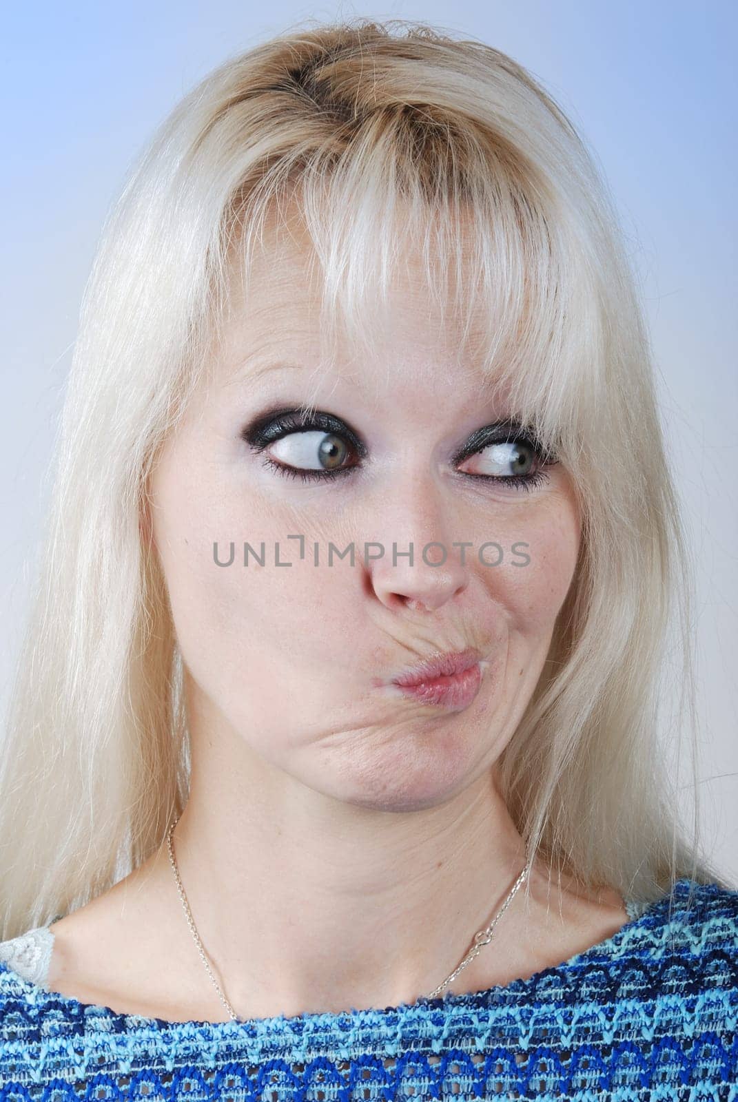 Young blond  woman making a face