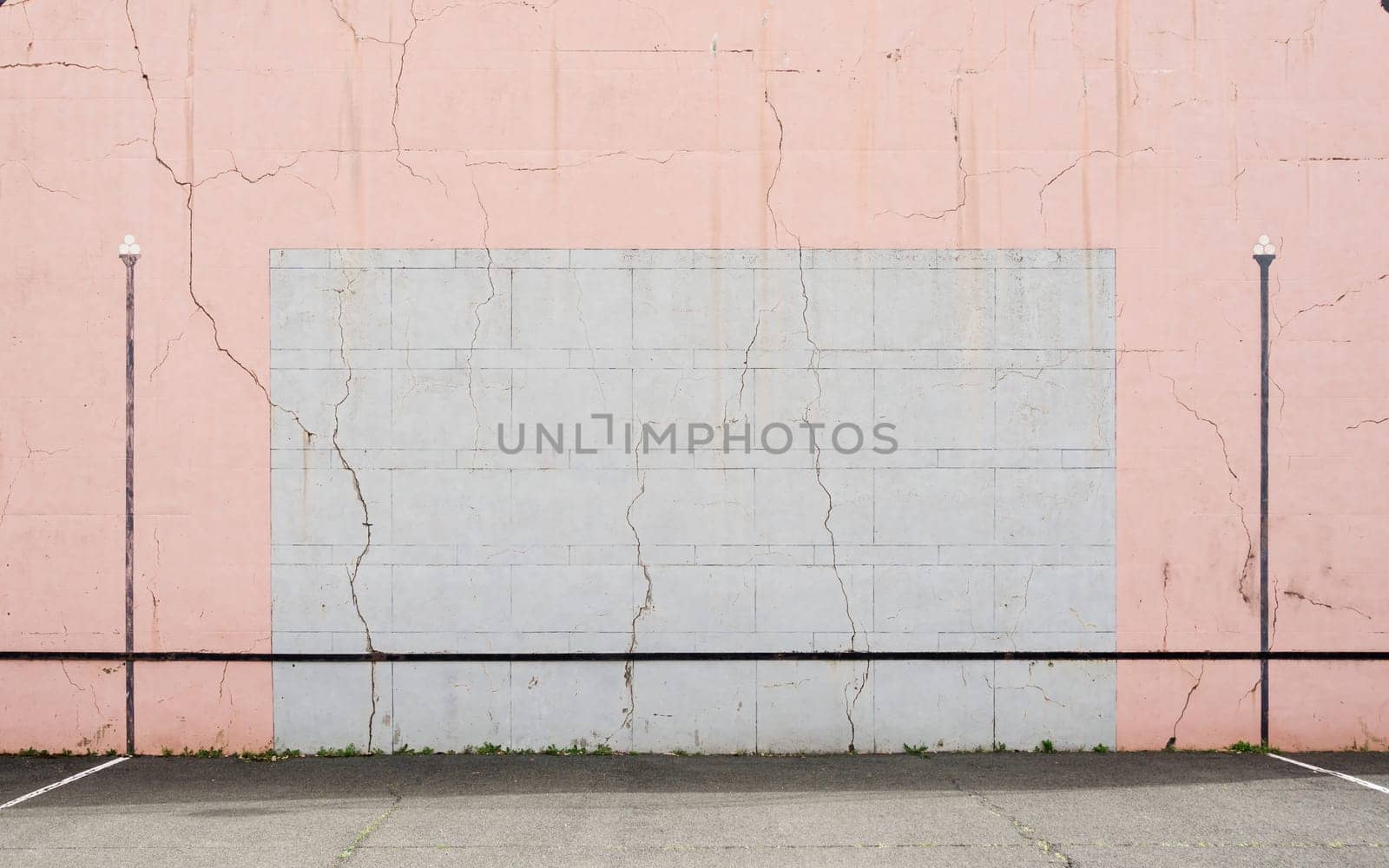 Cracked Basque pelota wall, pink and grey colours.