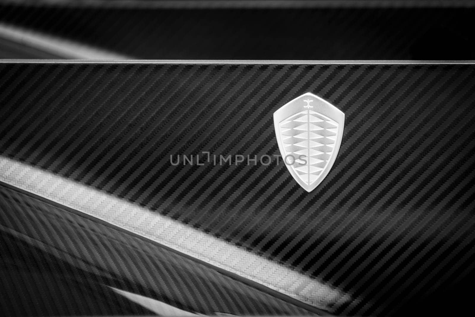 LONDON, UK - CIRCA JUNE 2014: Koenigsegg logo on One:1 carbon fiber bodywork, black and white photography.