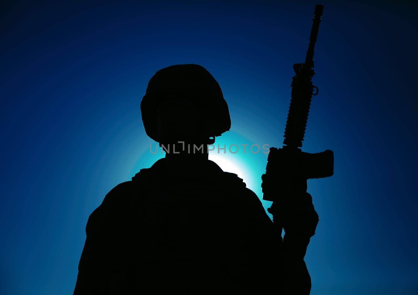 Night silhouette of army special operations forces soldier standing with service rifle on background of night sky with moon and stars. Modern warfare combatant in helmet, Marines raider in darkness