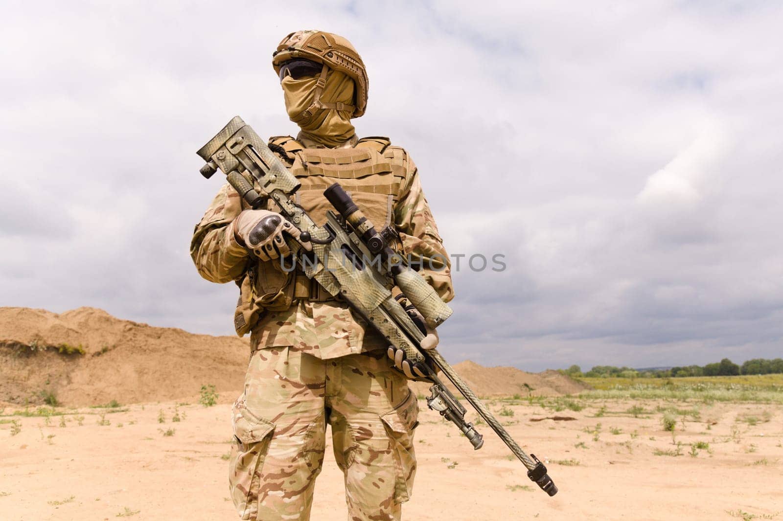 Fully equipped and armed special forces soldier with sniper rifle close-up.