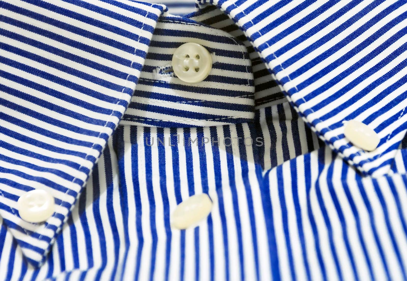 A blue striped shirt with a button down collar. Formal wear for events or work and business meetings