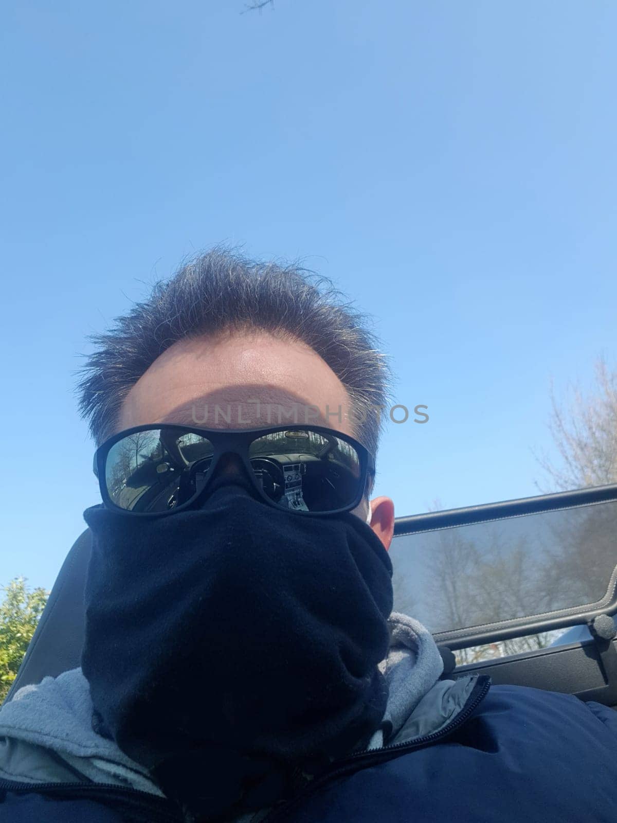 Shot of a serious looking man wearing a mask and sunglasses on infectious diseases.