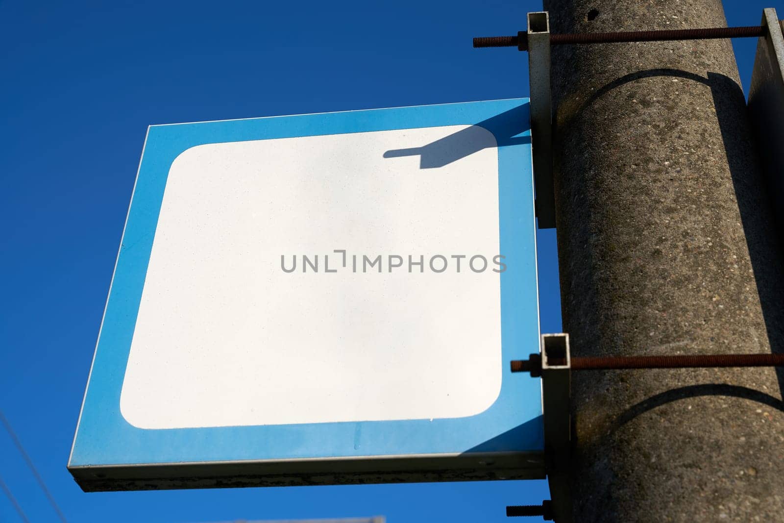 blank white sign with text space copy space without inscription on a pillar at the station