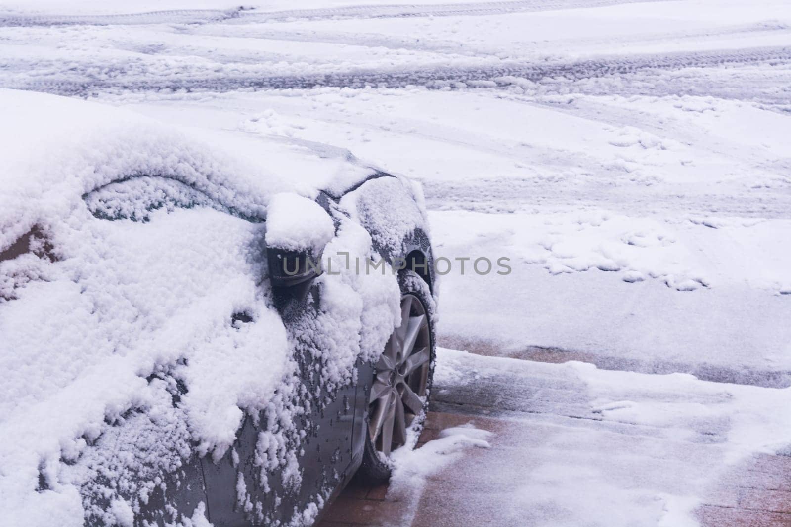 The car in the snow, covered with a white drift of snow.