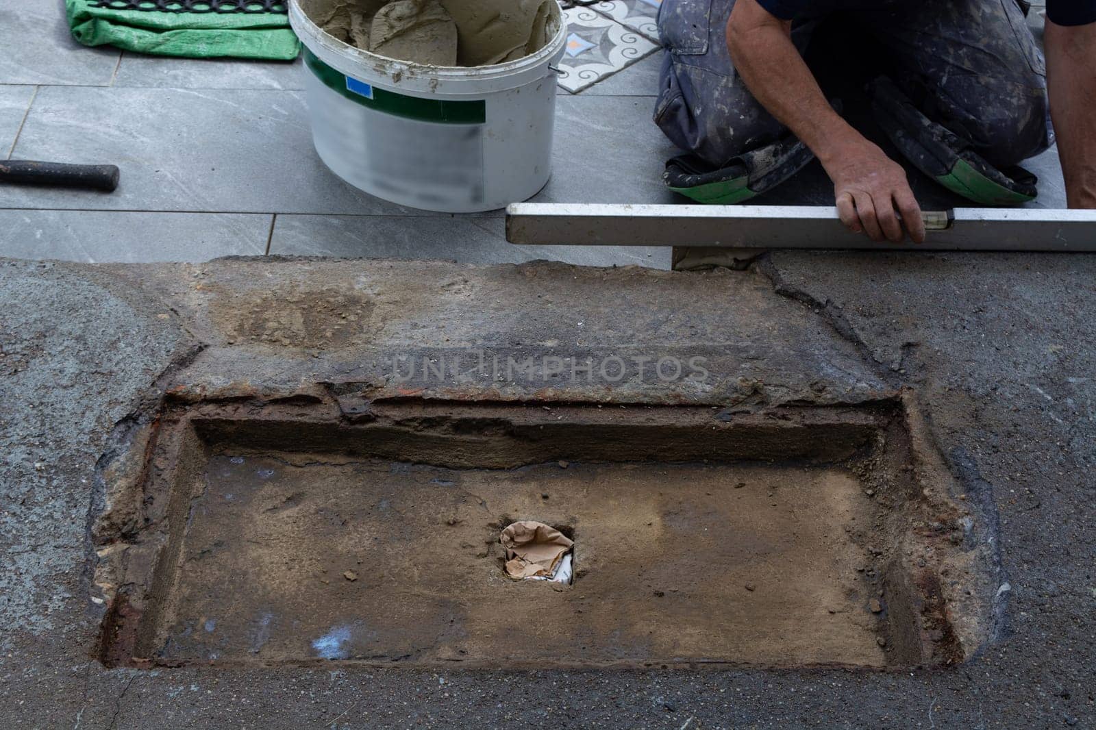 Laying ceramic floor tiles - man hands closeup