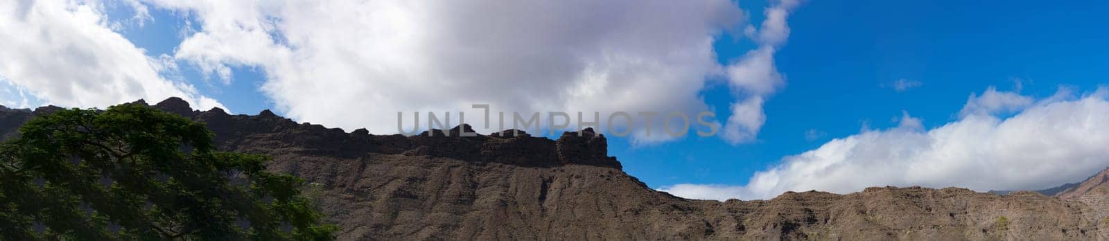 Mountains on the coast between Puerto de Mogan and Puerto Rico. Layers of volcanic rock.