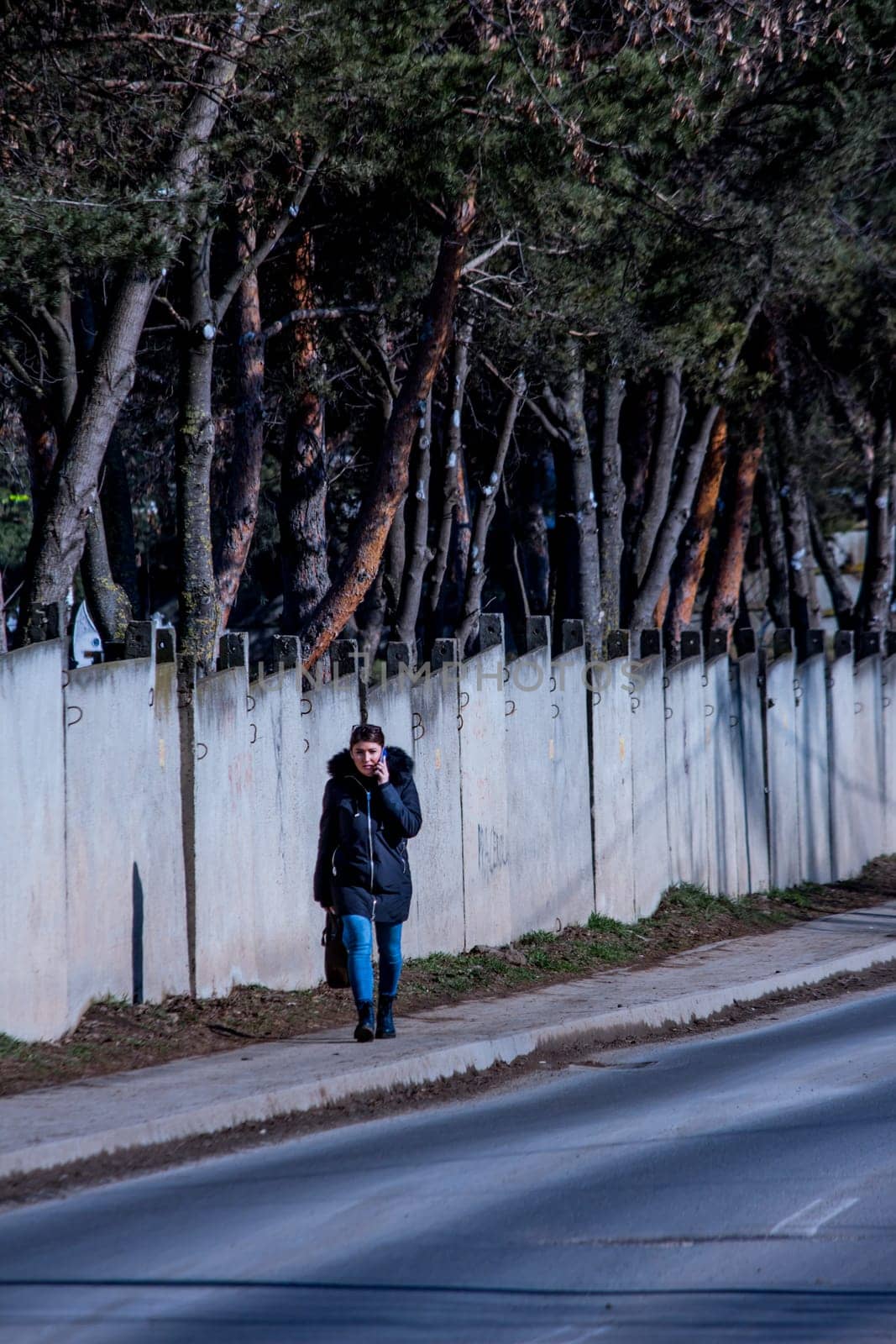 Iasi - Romania - 13th March 2021: Women walking on the sidewalk during a sunny day