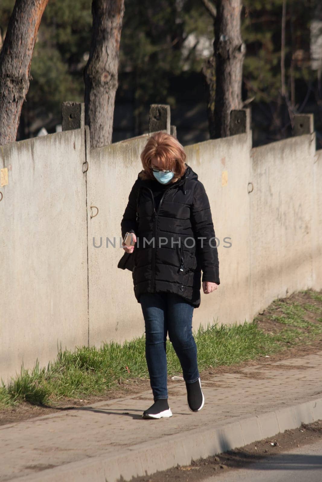 Iasi - Romania - 13th March 2021: Women walking on the sidewalk during a sunny day