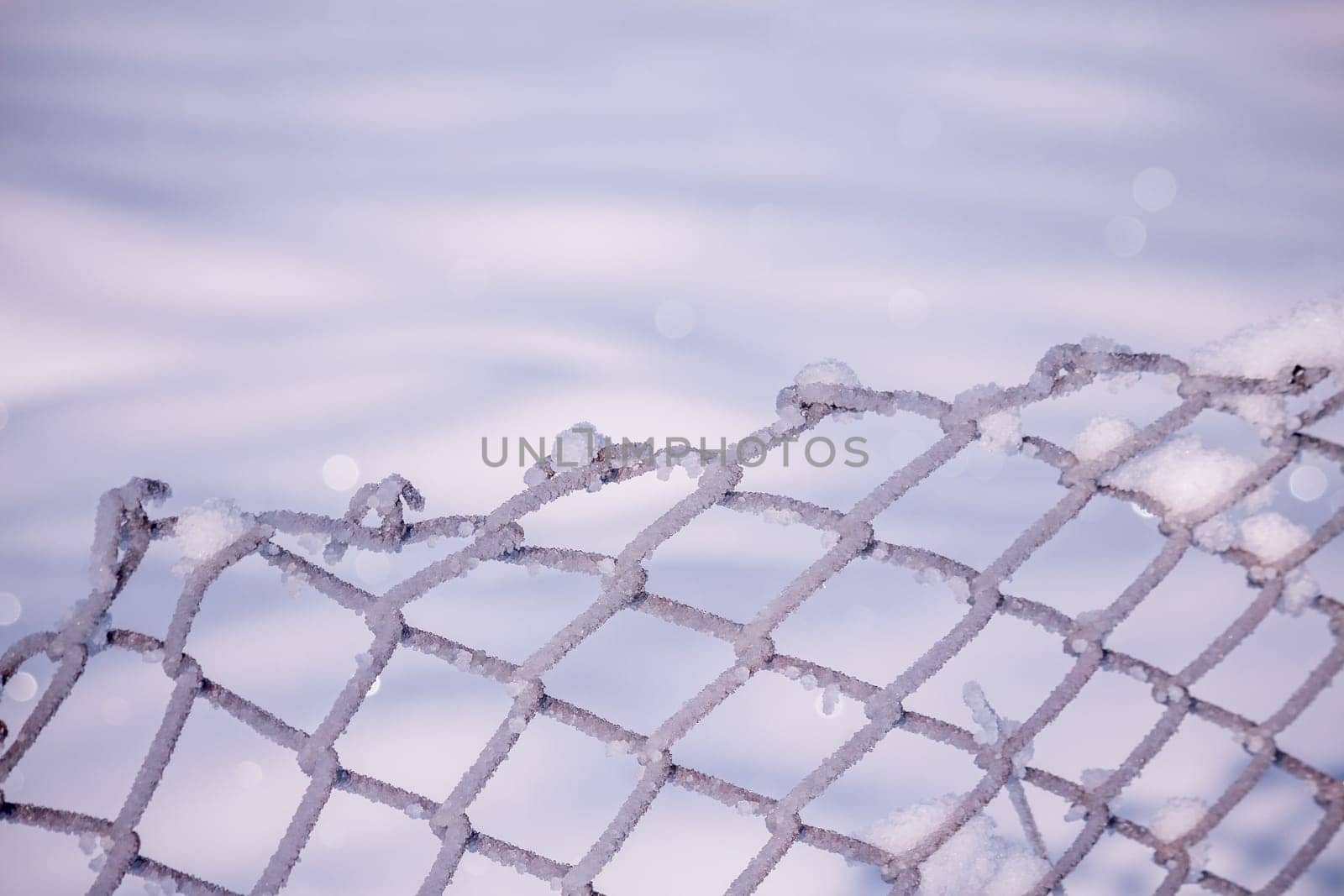 Steel fence covered in snow during winter