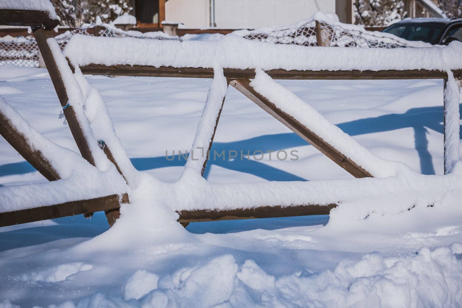 Wood fence covered in snow during winter