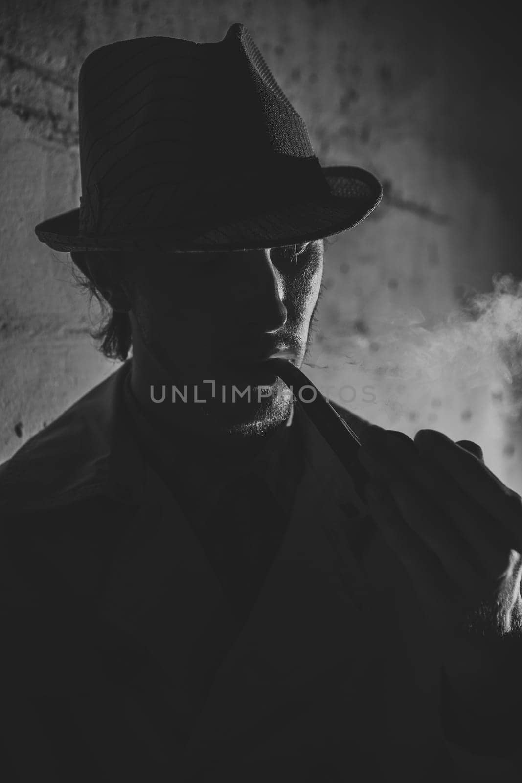 Black and white old-fashioned portrait of man with cigar