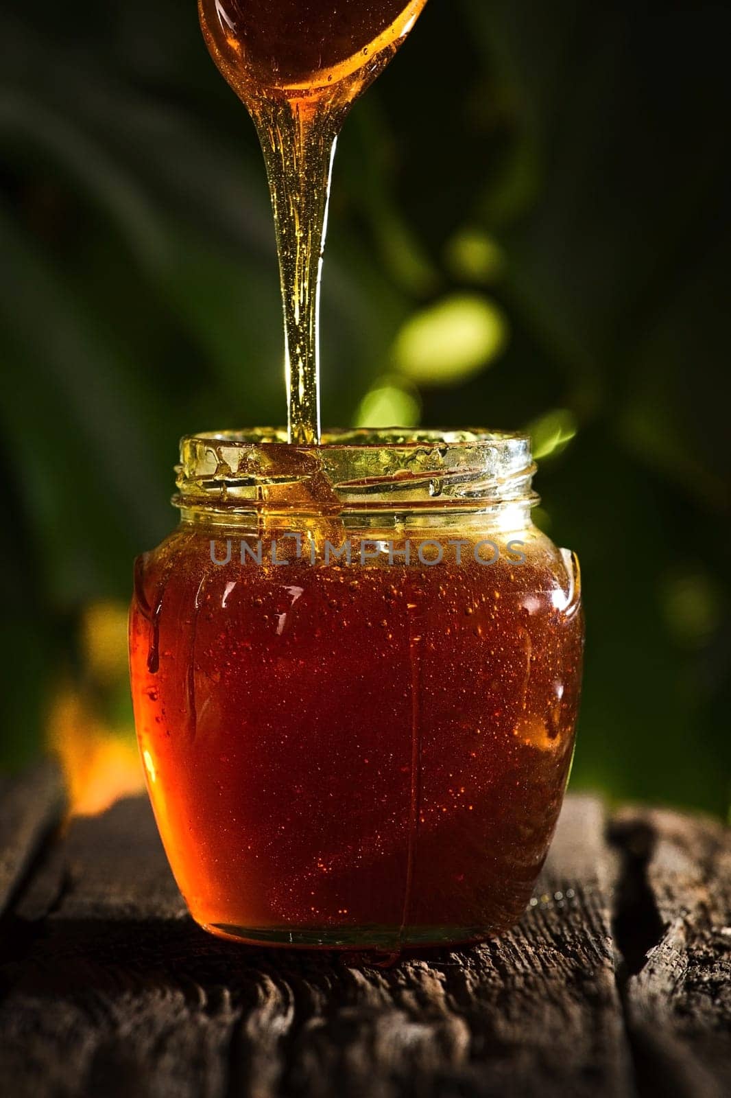 Close-up shot of flowing honey over yellow background