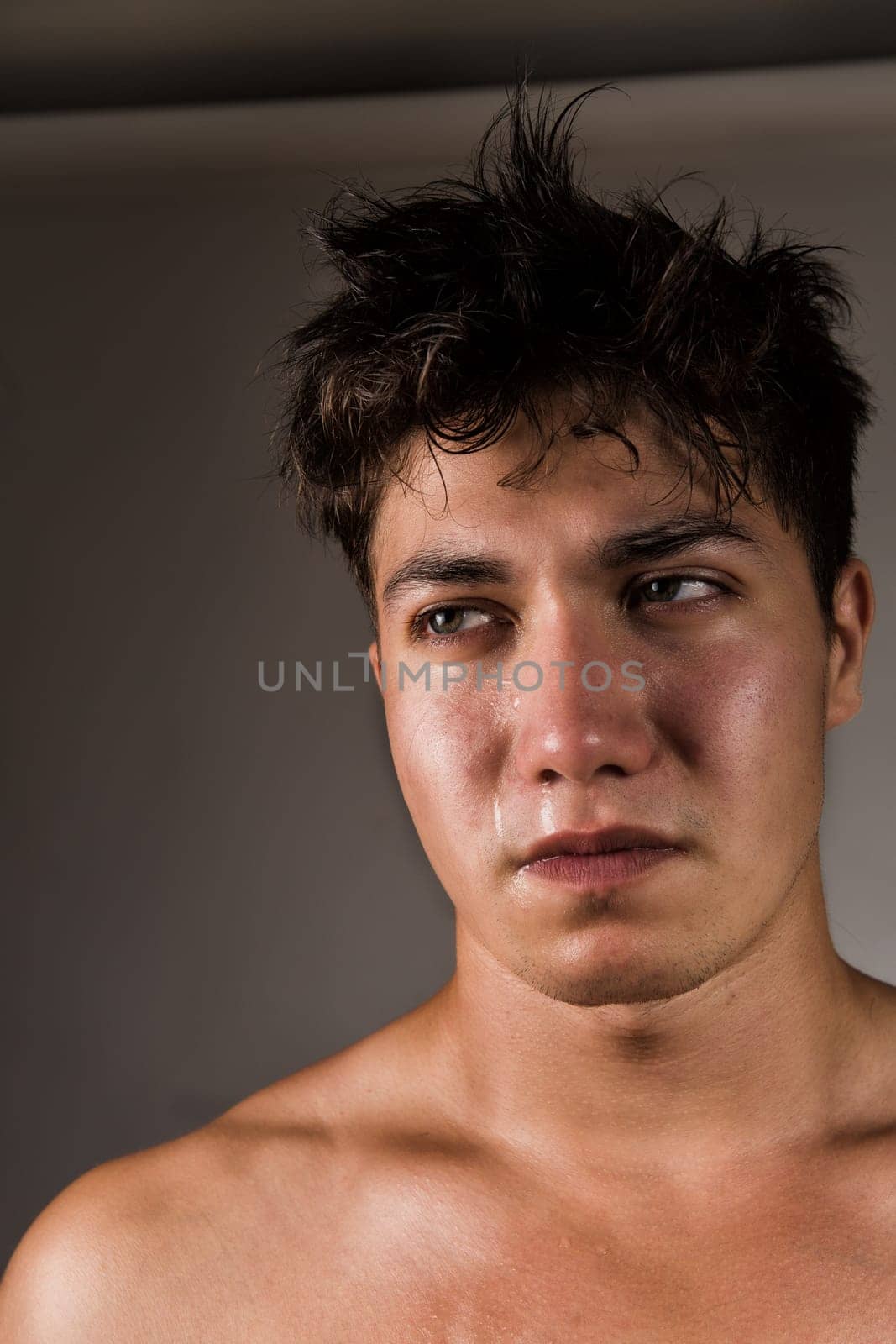 Crying man with tears in eye closeup