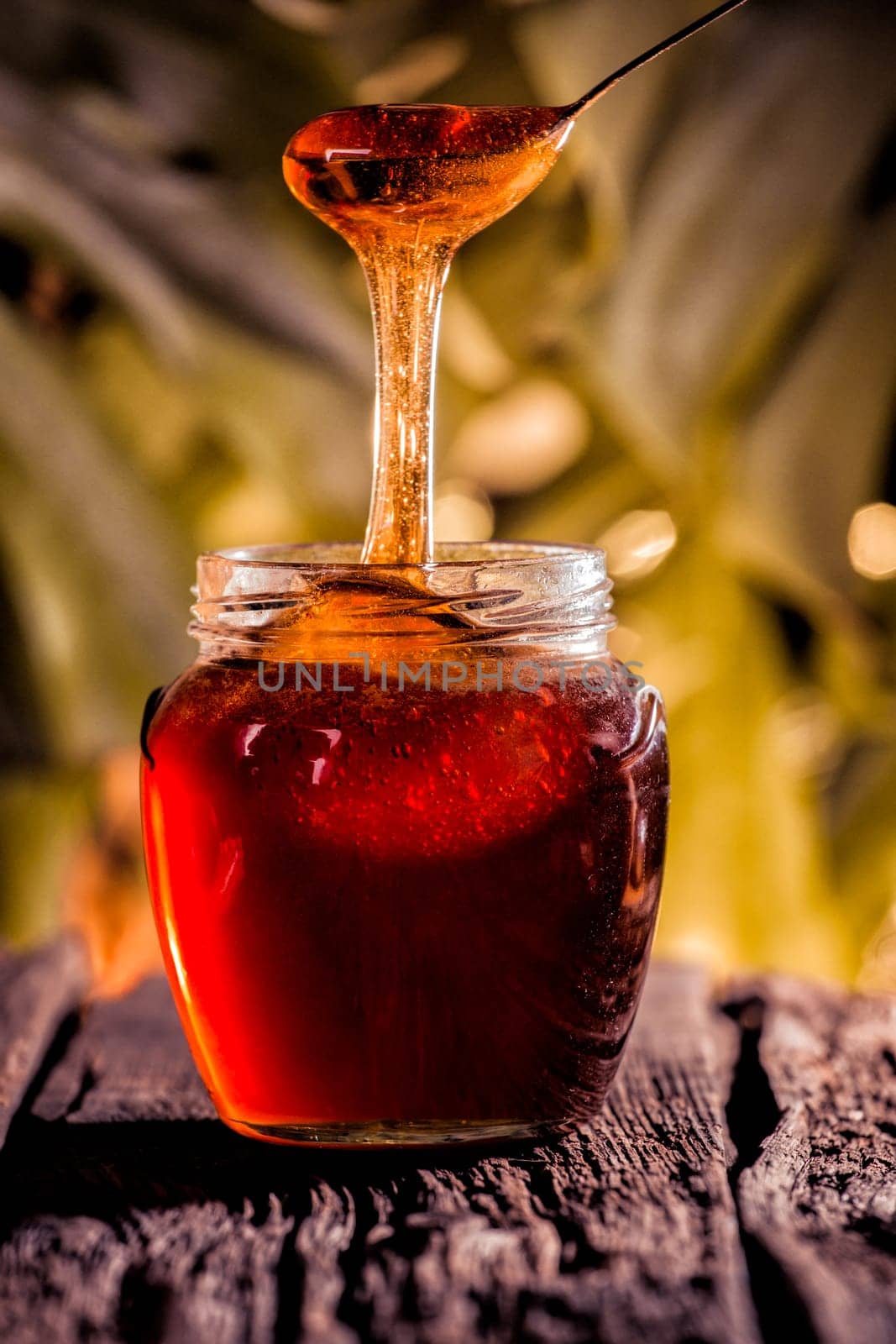 Honey drip in jar on the table
