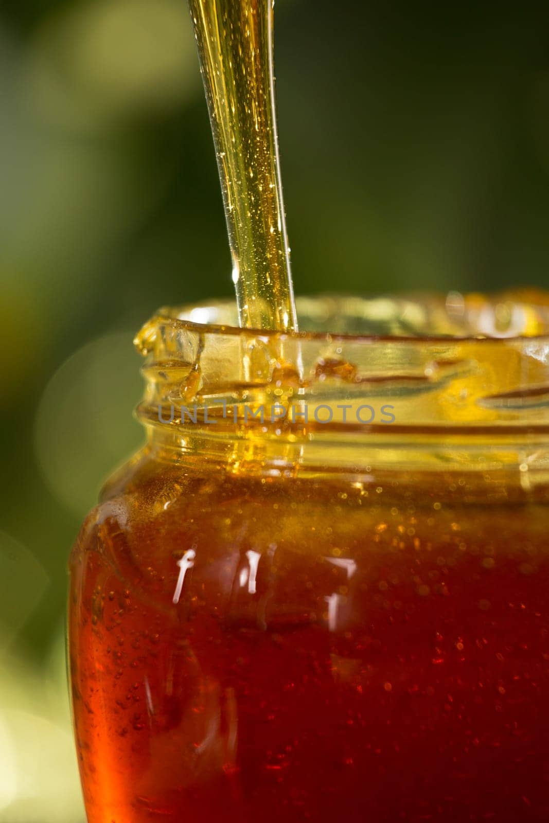 Close-up shot of flowing honey over yellow background
