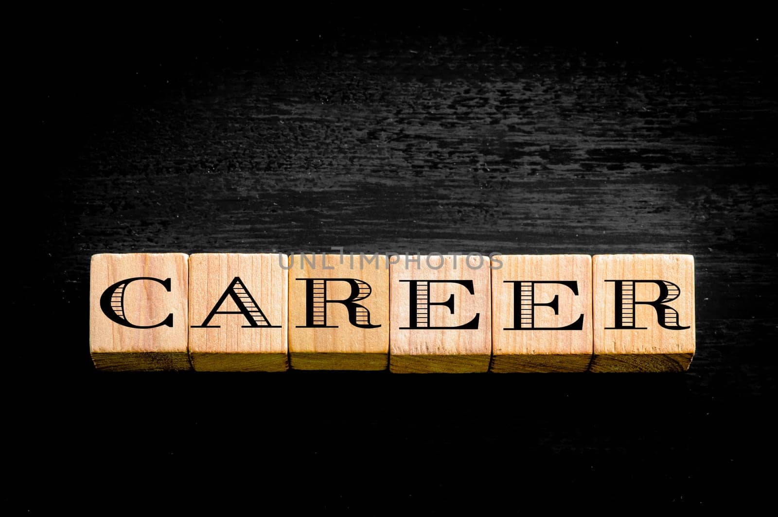 Word Career. Wooden small cubes with letters isolated on black background.Concept image.