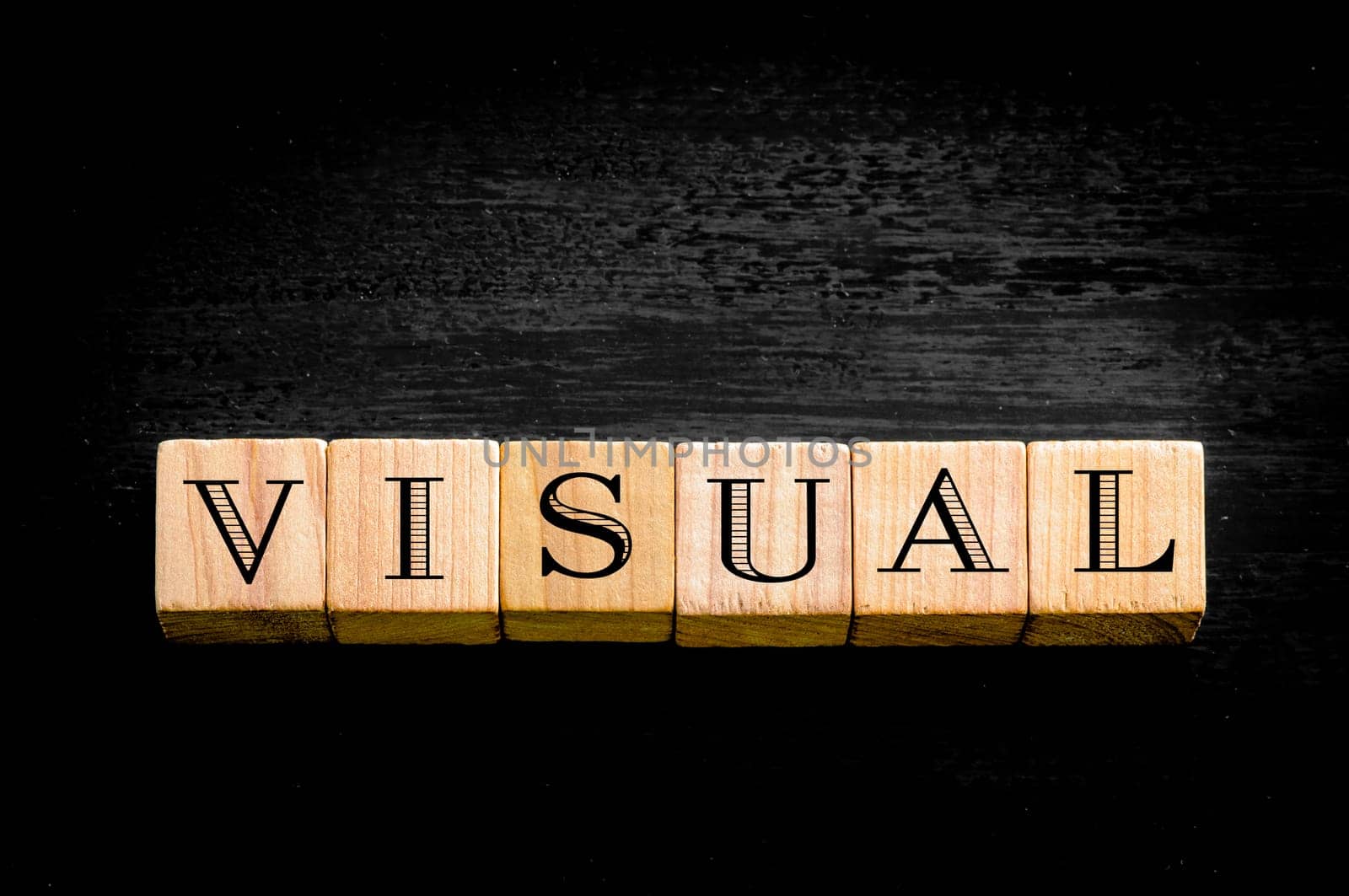 Word Visual. Wooden small cubes with letters isolated on black background.Concept image.