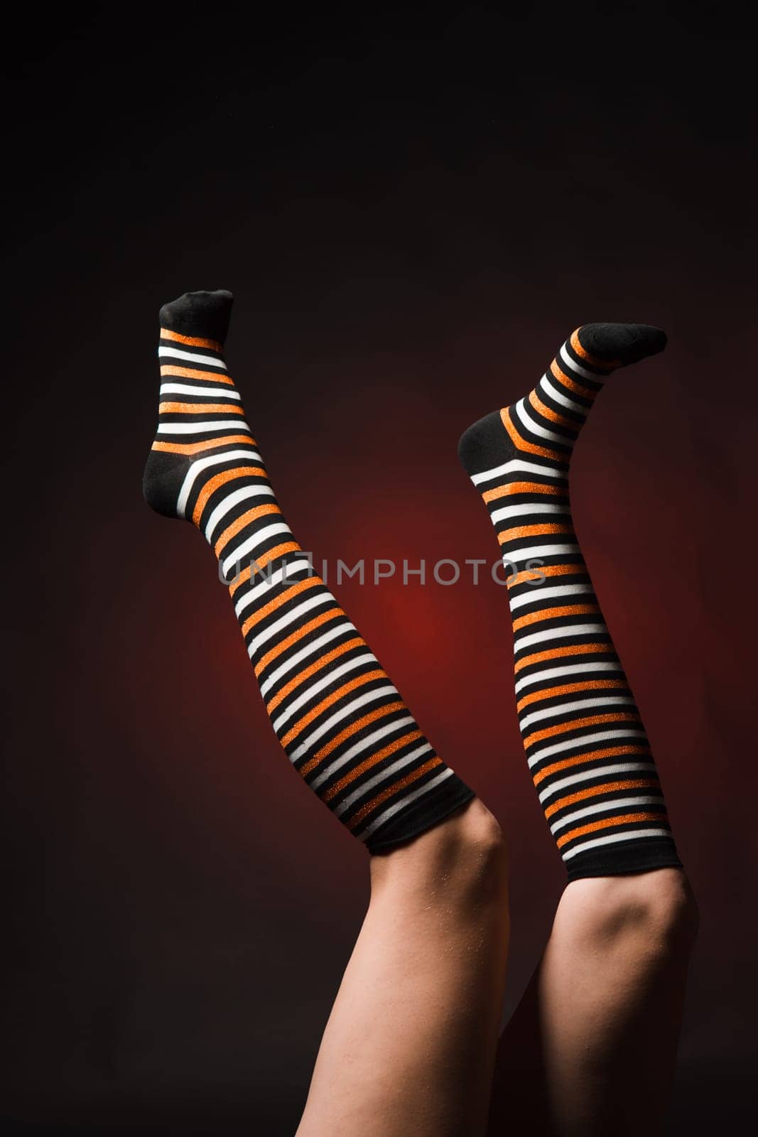 Pretty legs in a long multi-colored socks