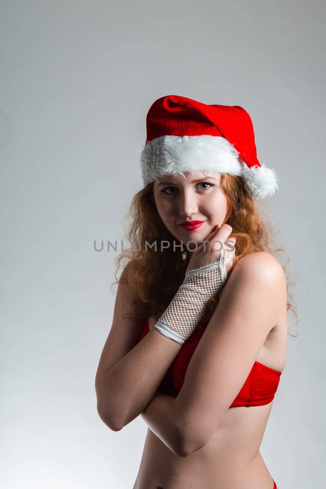 Pretty Santa girl closeup portrait, holding present gift box isolated on white background