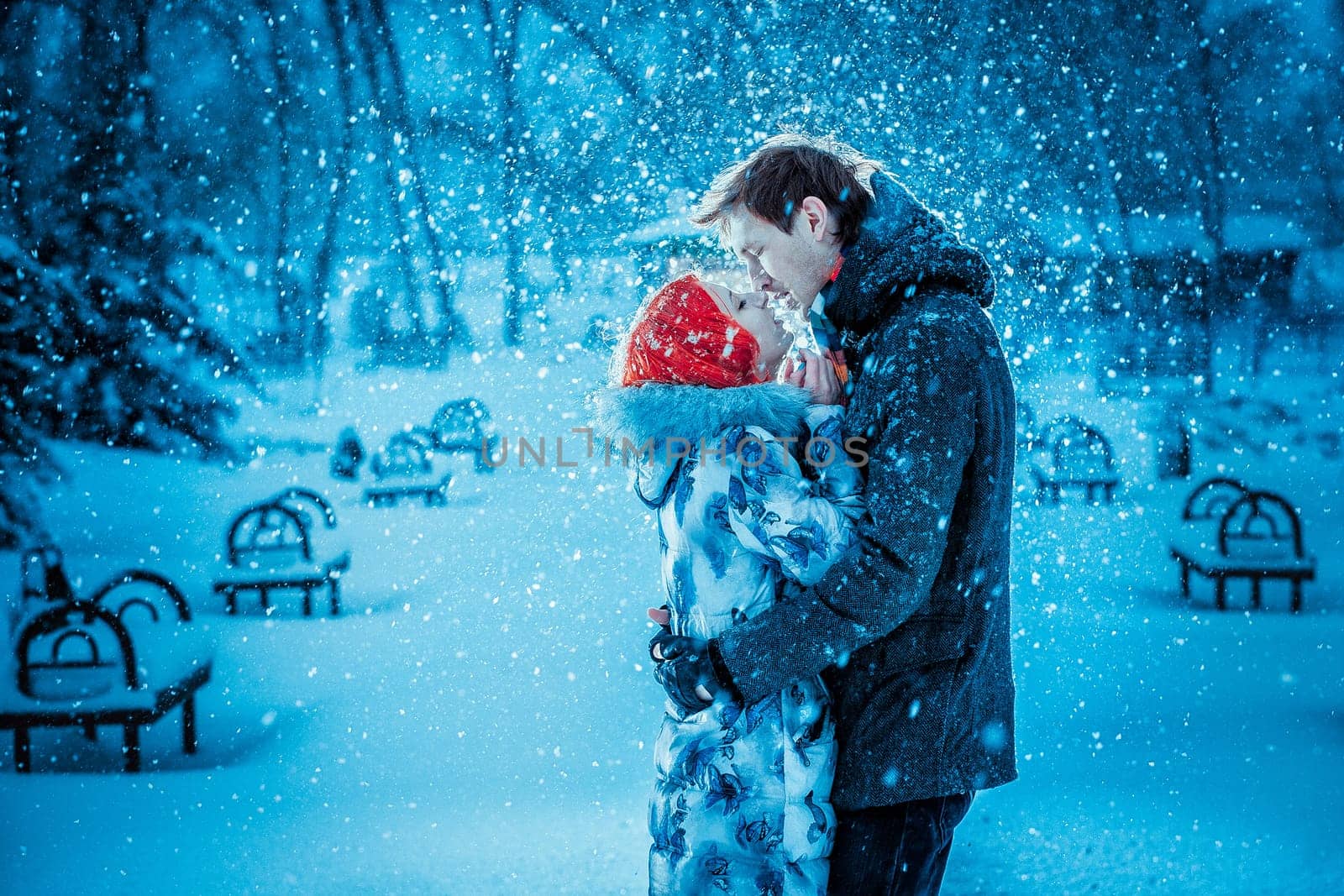 Happy Young Couple in Winter Park having fun.Family Outdoors. love kiss