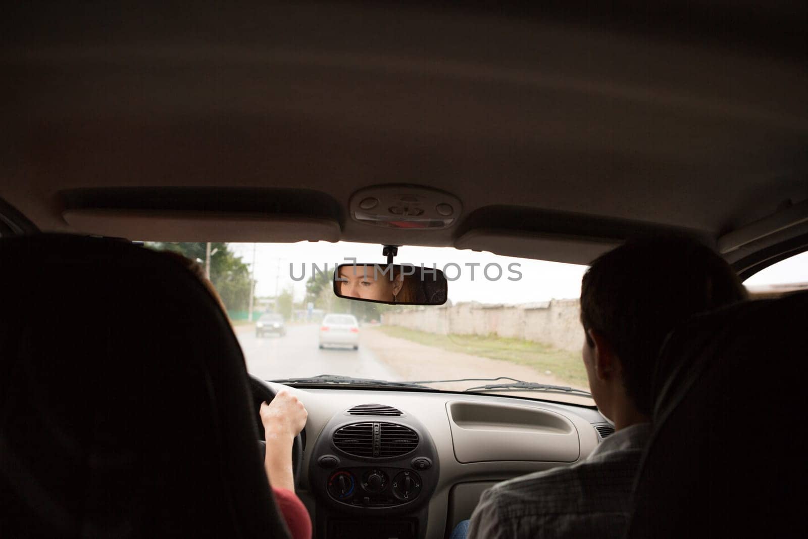 young woman in car - indoor keeps wheel turning around looking at passengers sitting side idea of taxi driver talking to policeman companion companion who asks for directions right drive Documents