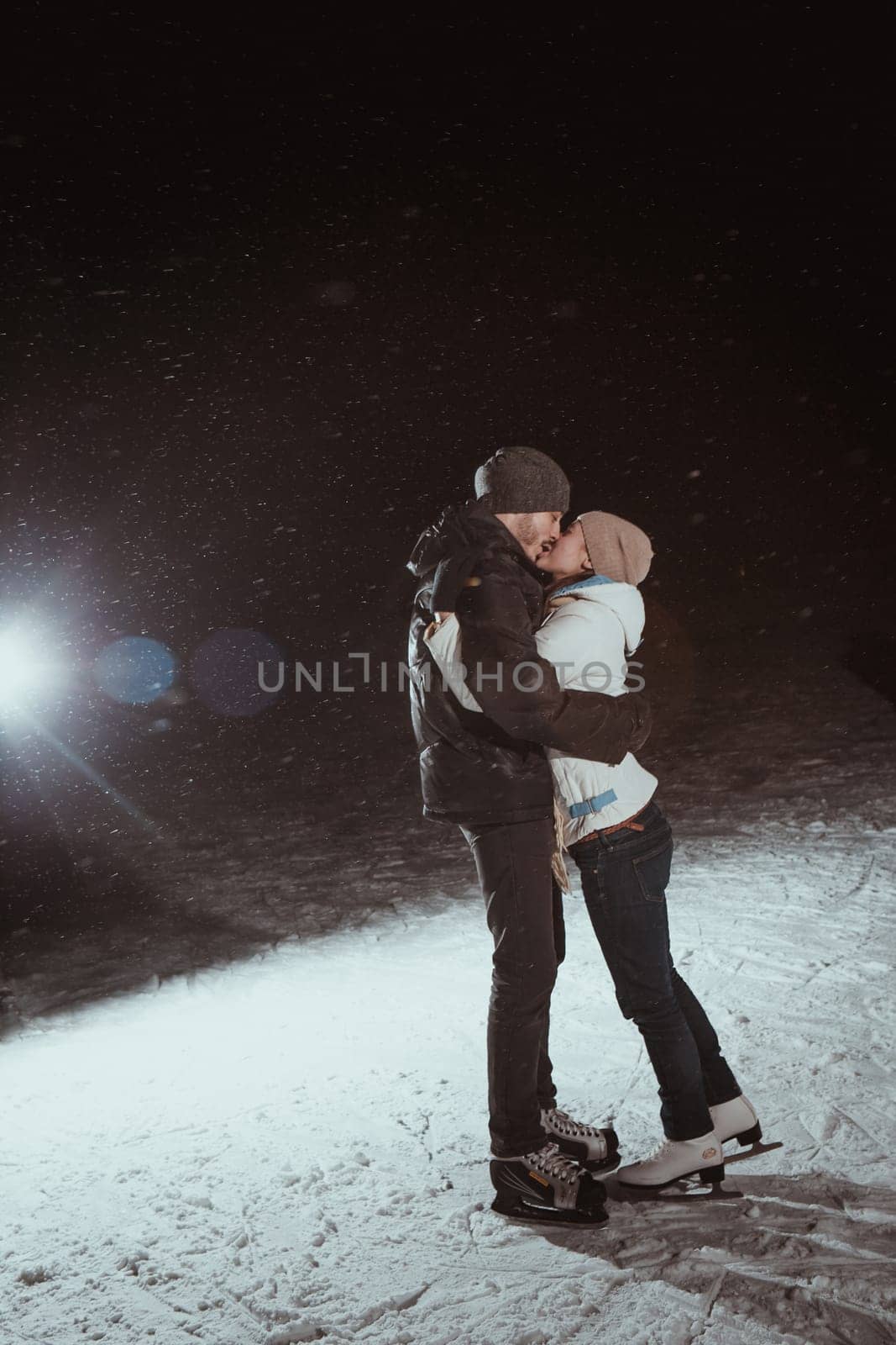 young couple in winter skate rink
