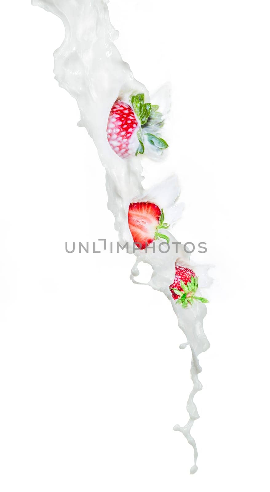 Strawberry falling into milk splashing. Close up view, On white background.