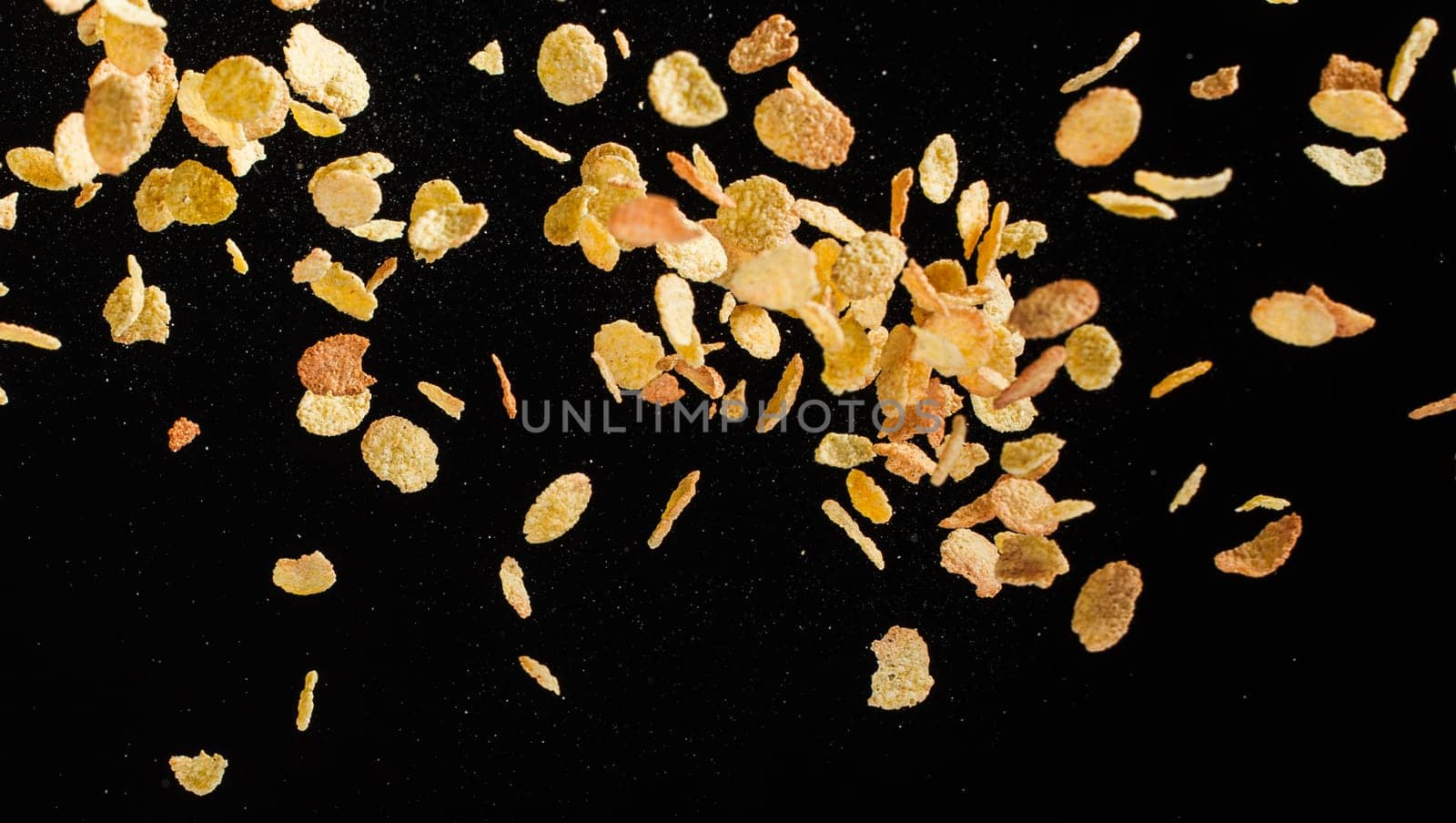 Flying corn flakes isolated on black background