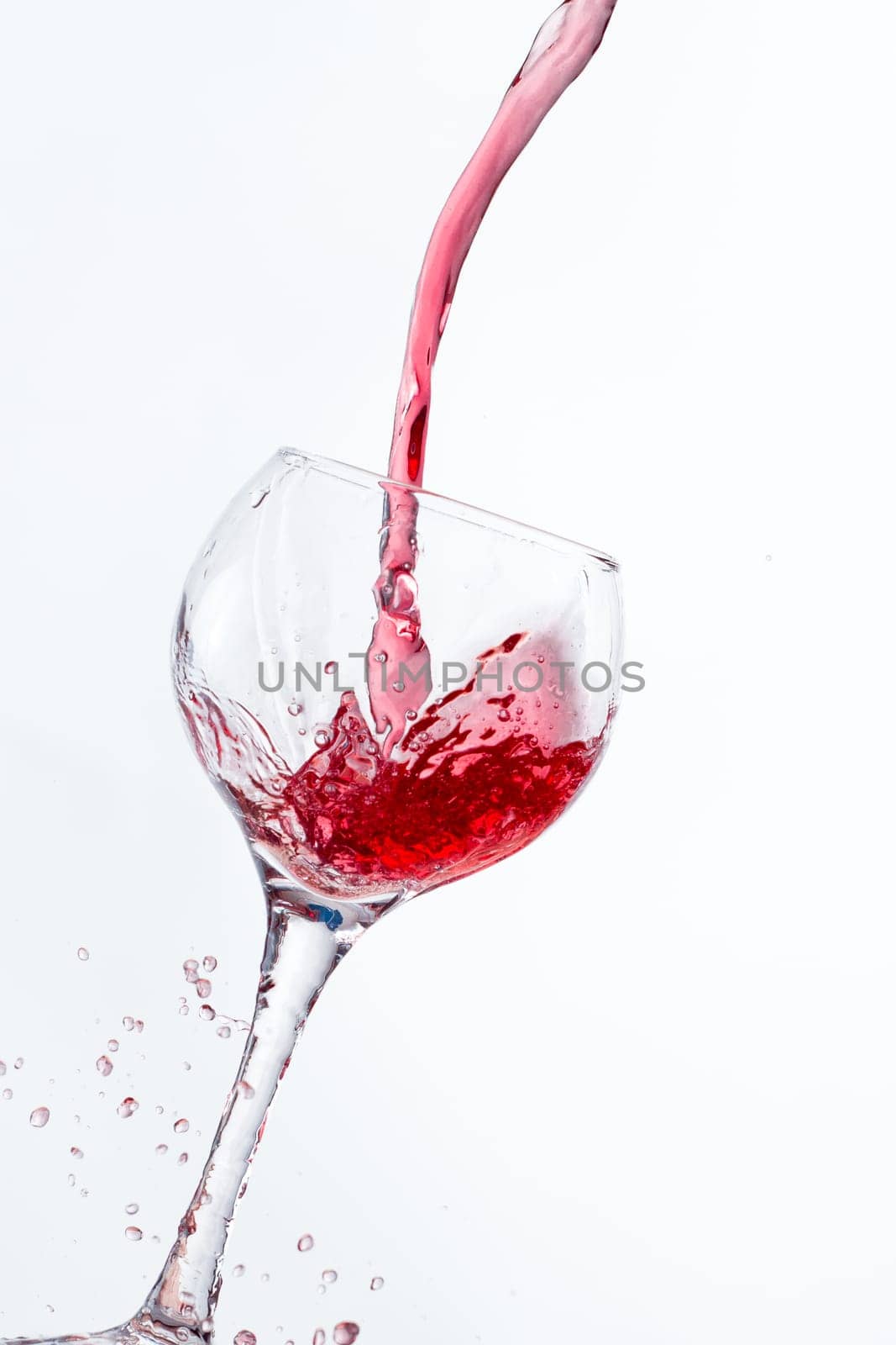 Red Wine Pouring into glass white isolated