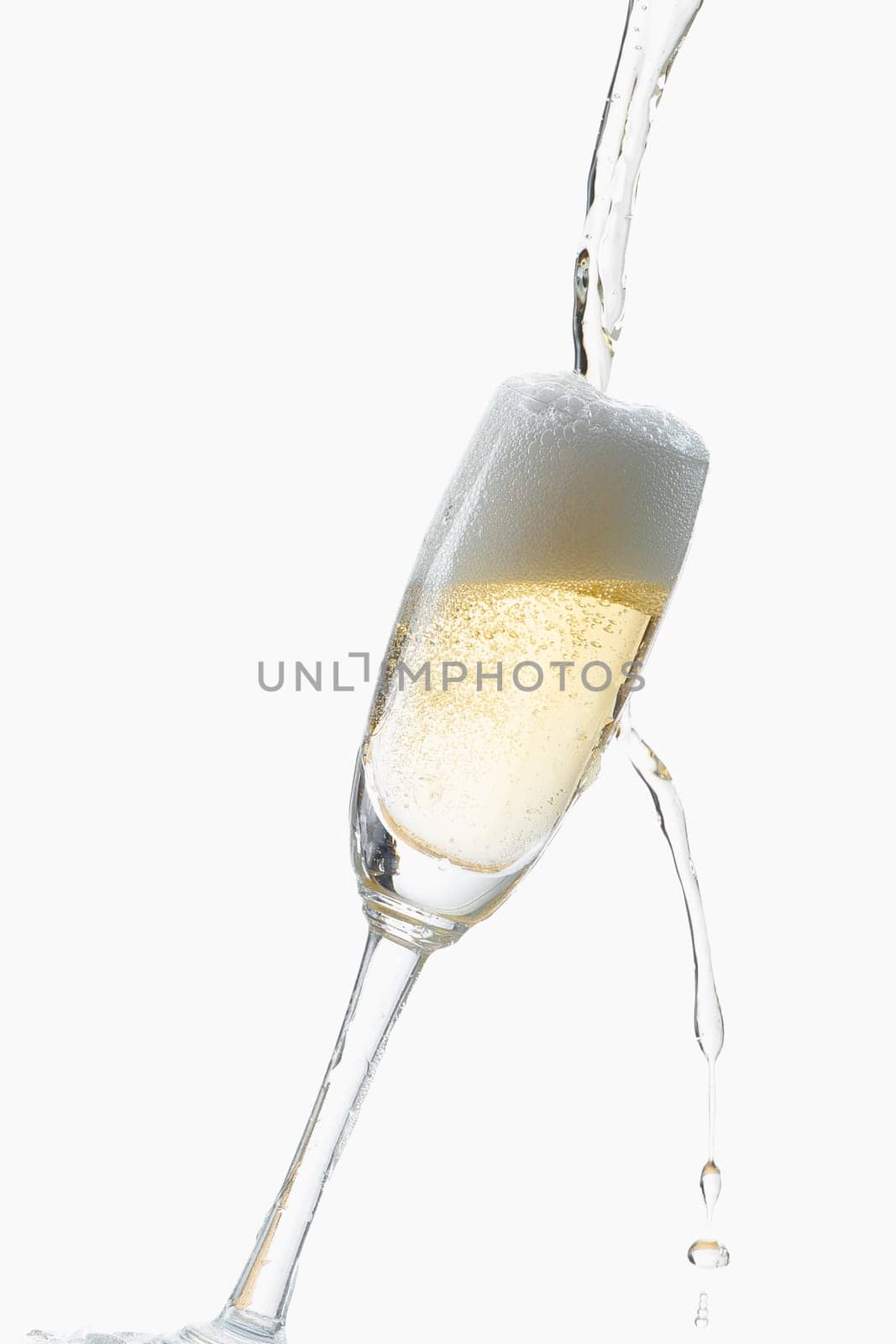 White wine splashing out of glass, isolated on white background