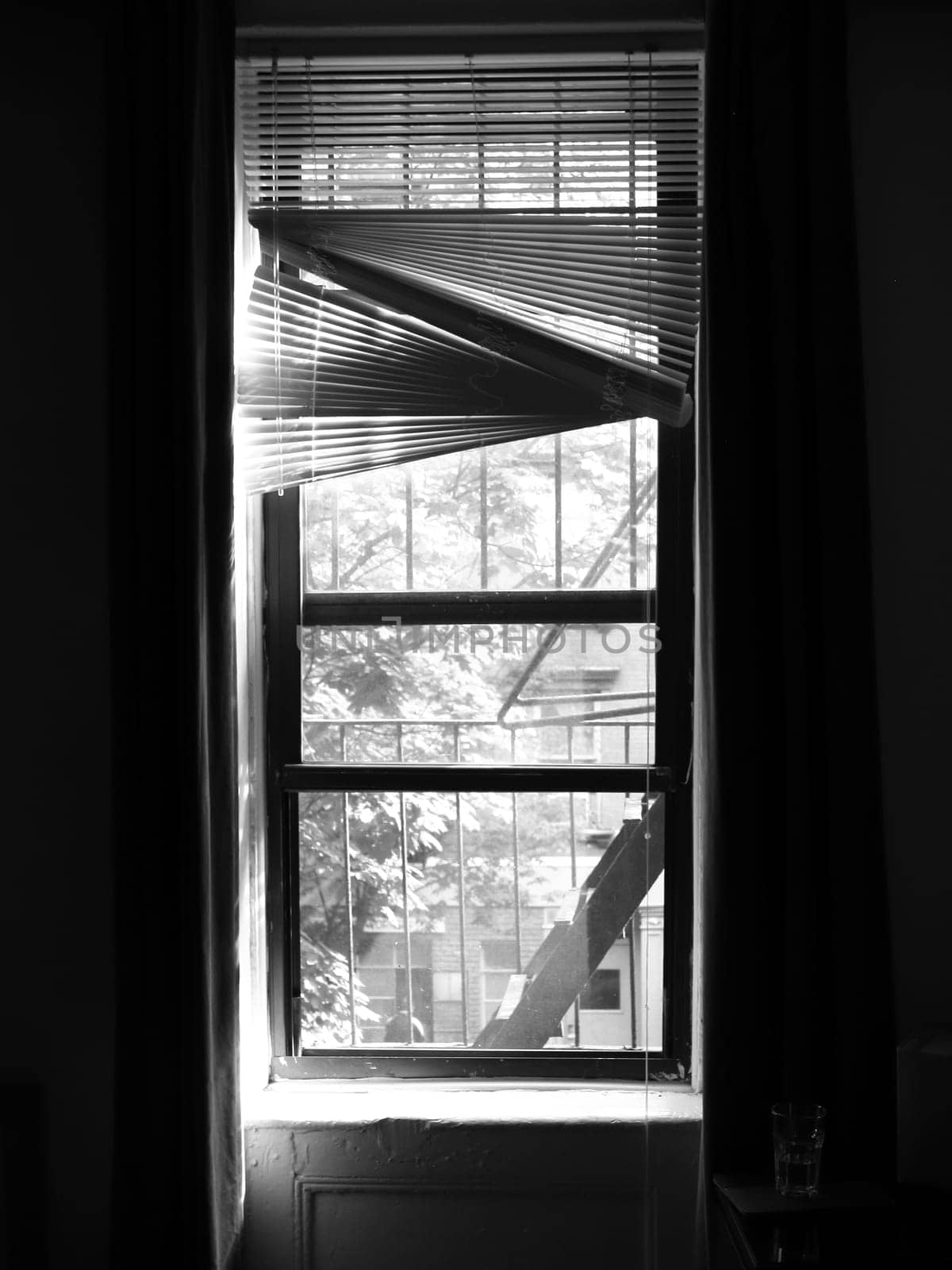 Inside Out Window with Worn Blinds in New York Apartment