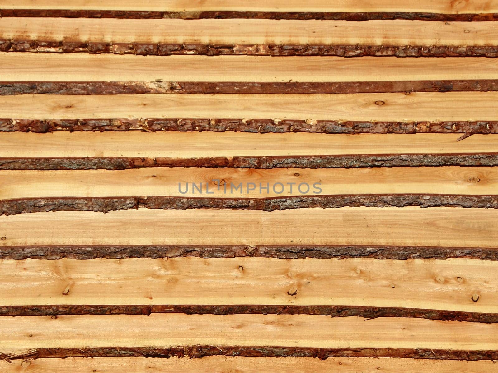 Rough wooden pine planks with bark on the side. It resembles a set of stairs.