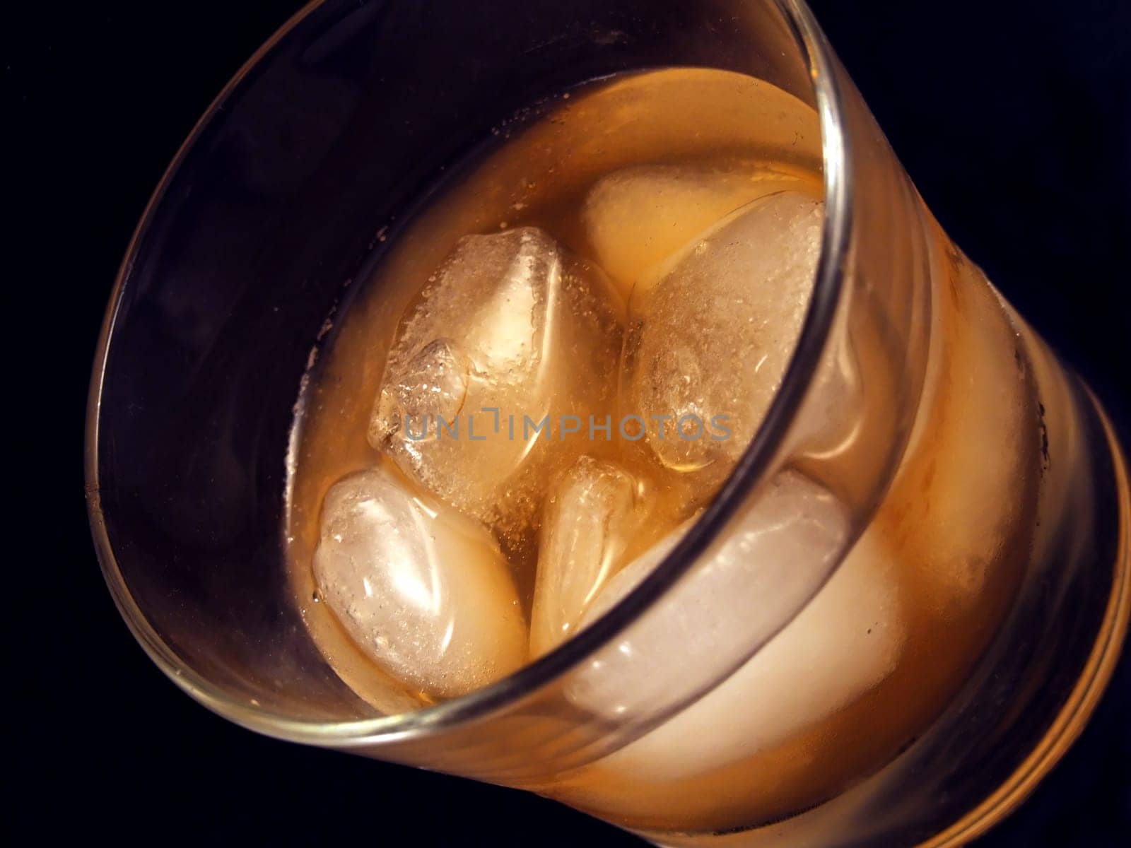 Glass of alcoholic drink with ice