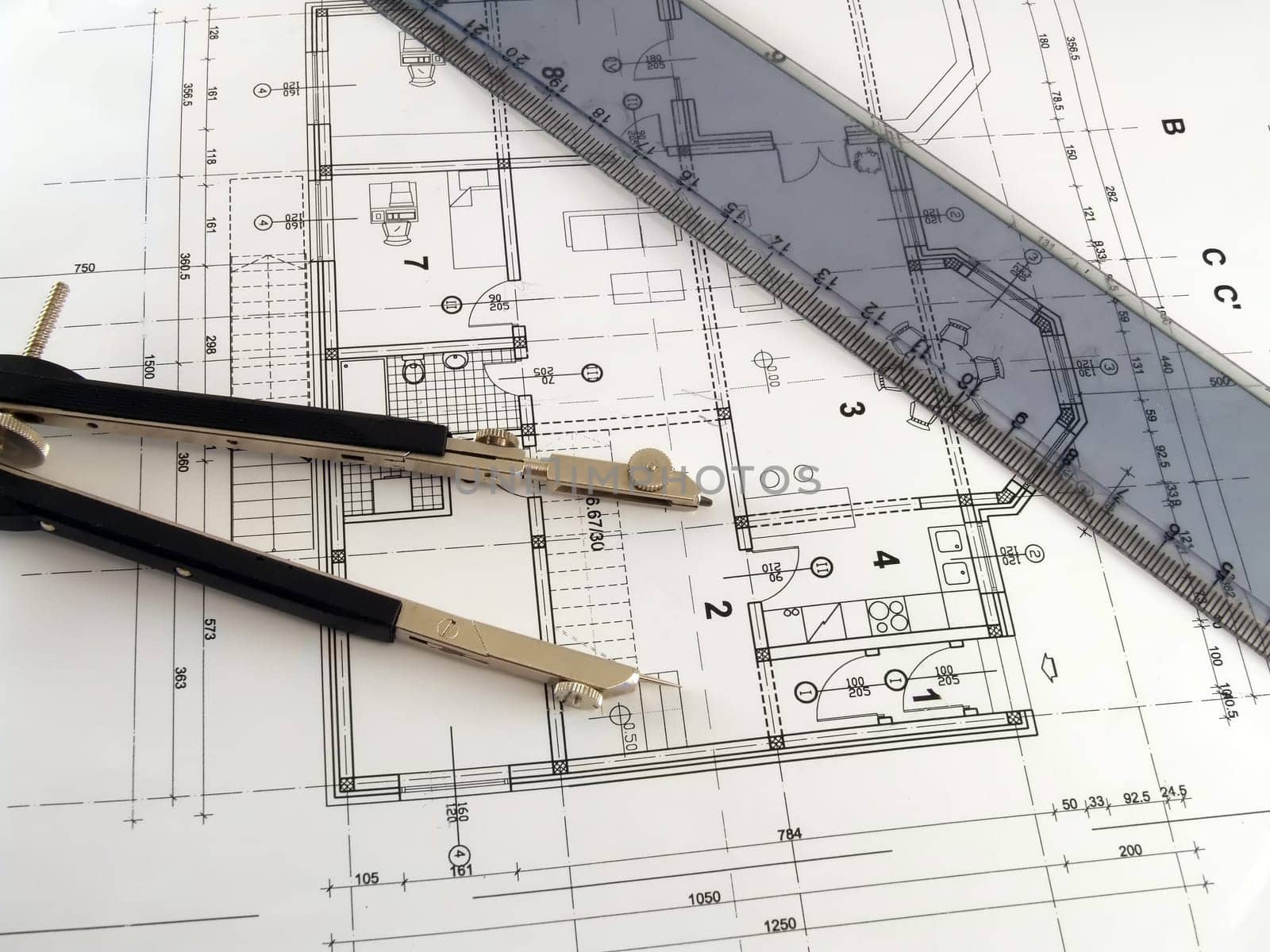 dividers and ruler laying on architectural plan