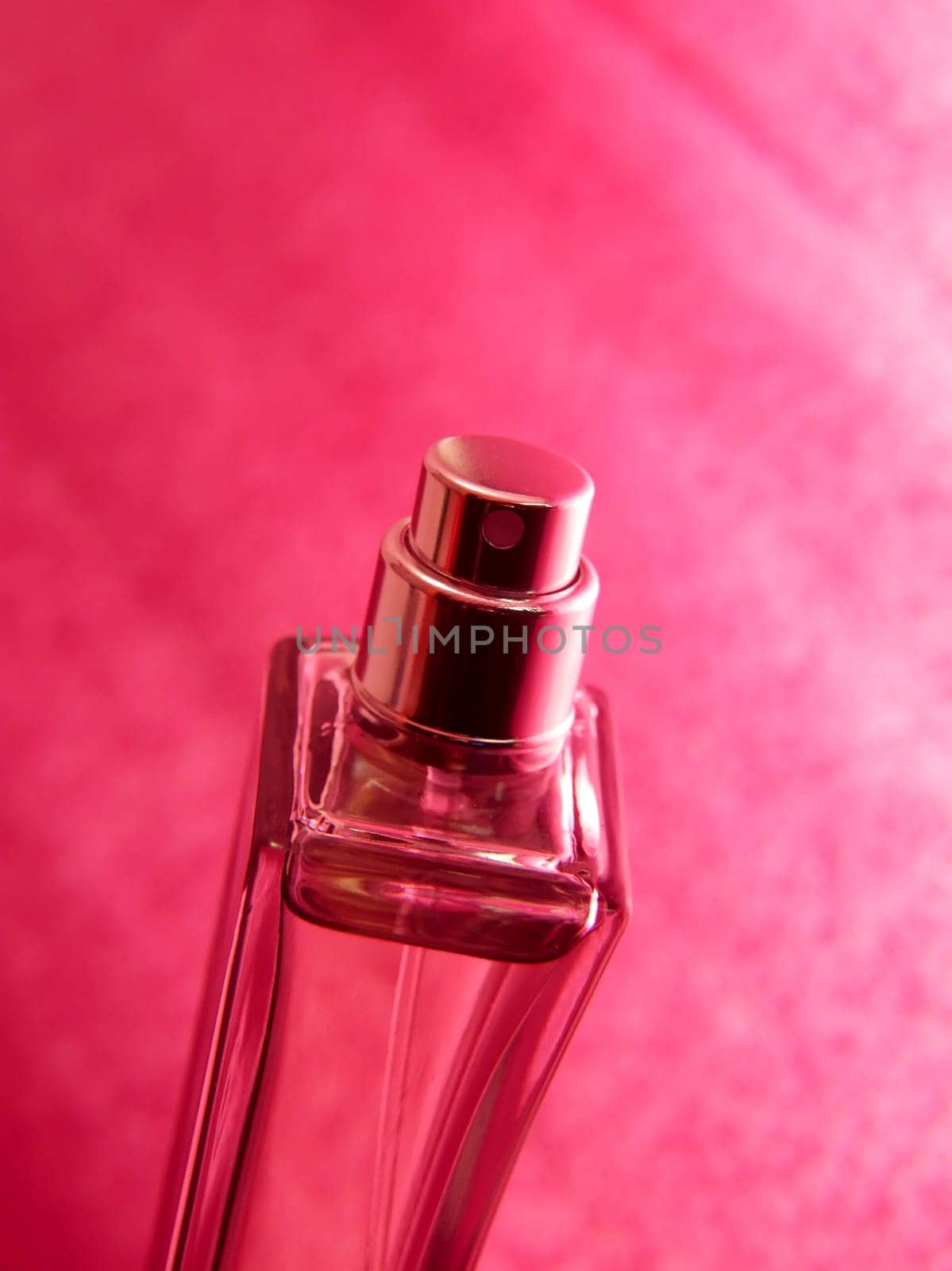 Bottle og parfume over pink background