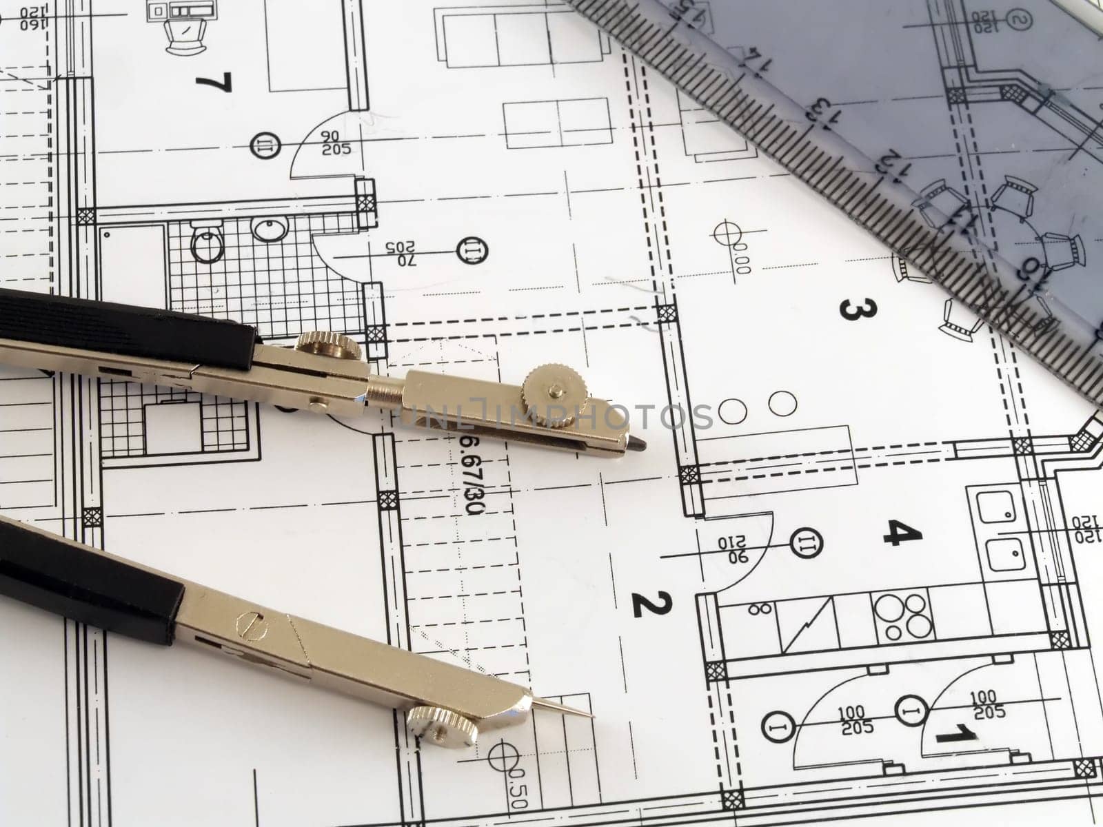 dividers and ruler laying on architectural plan