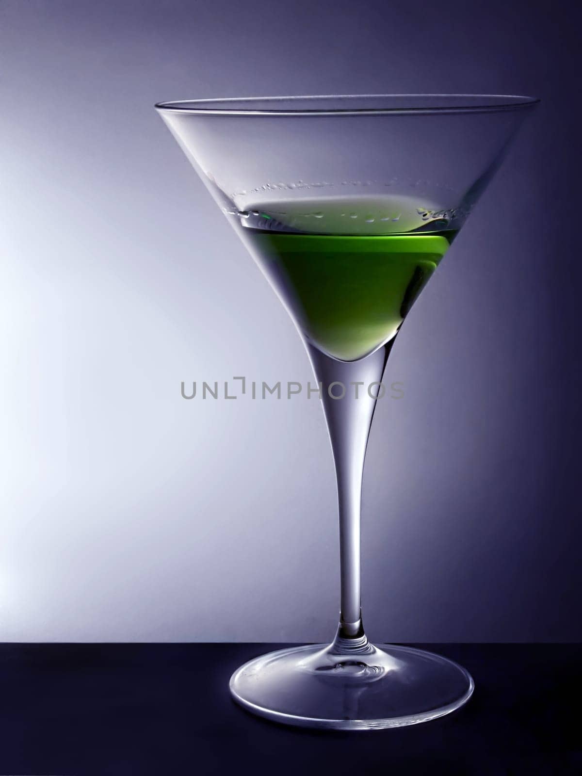 Cocktail glass with green beverage