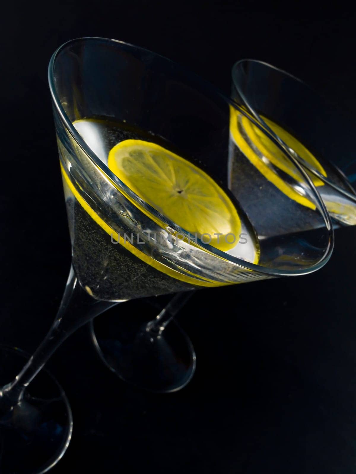 martini with lemon over black