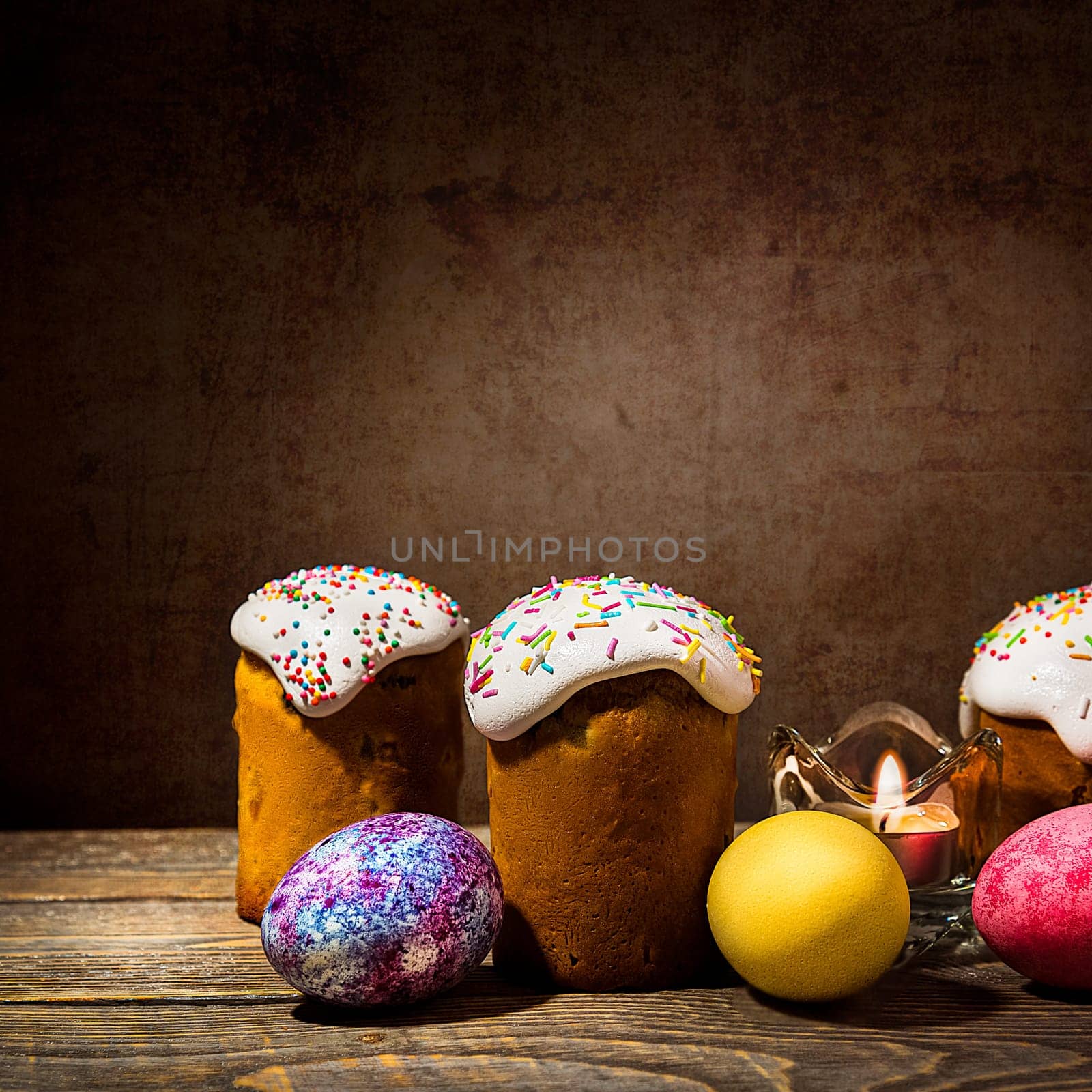 Easter cakes and Easter colored eggs on a dark background. Religious holiday of bright Easter.