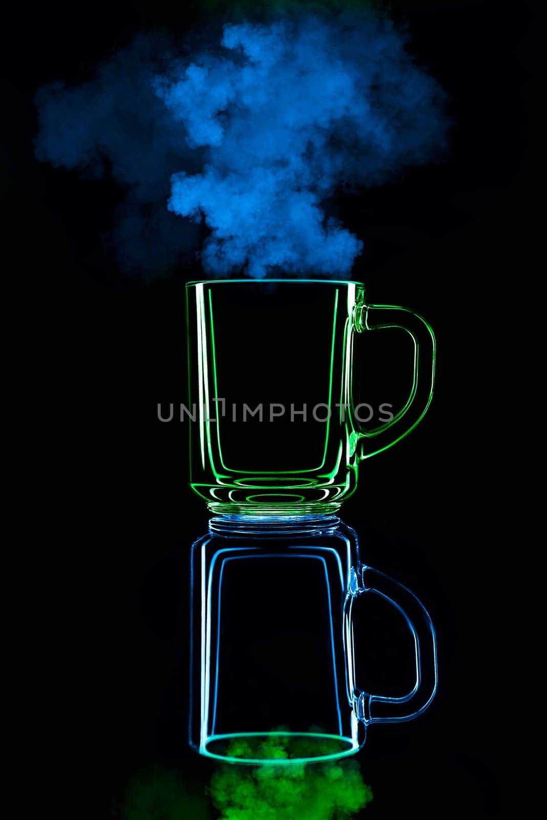 Just a glass on a black background with a reflection. Blue and green, with steam. Isolated.