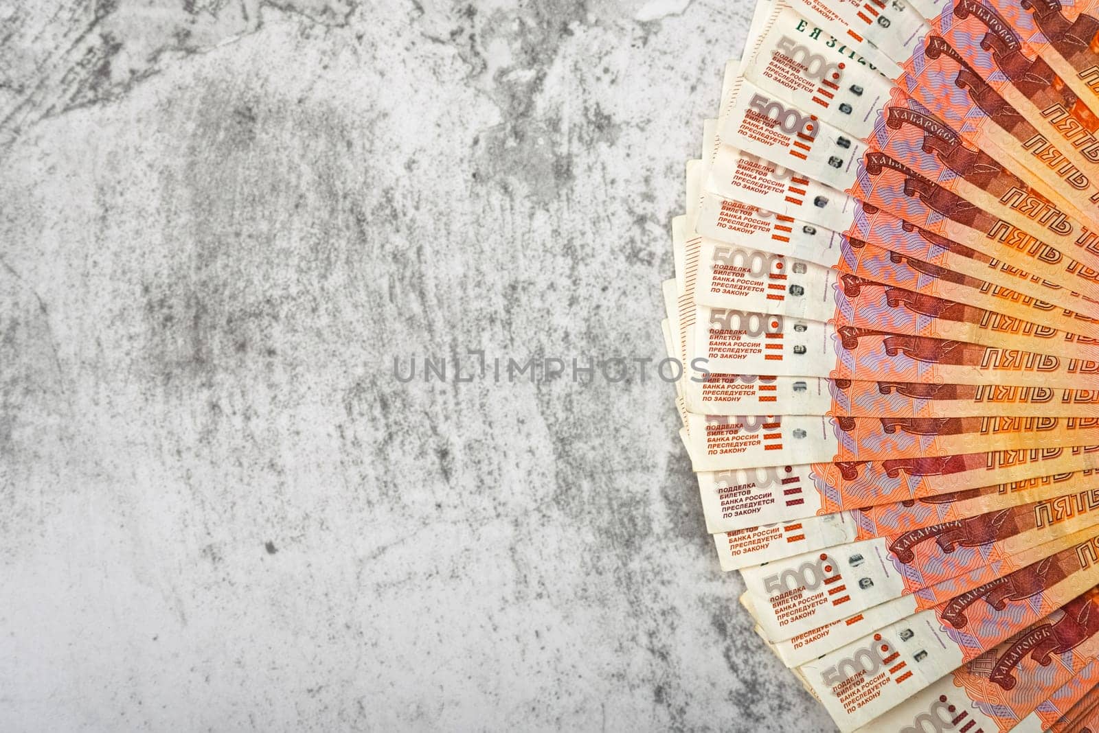 Russian money banknotes of five thousand rubles, background, banknotes are arranged in a fan on a gray background. Layout, mockup.