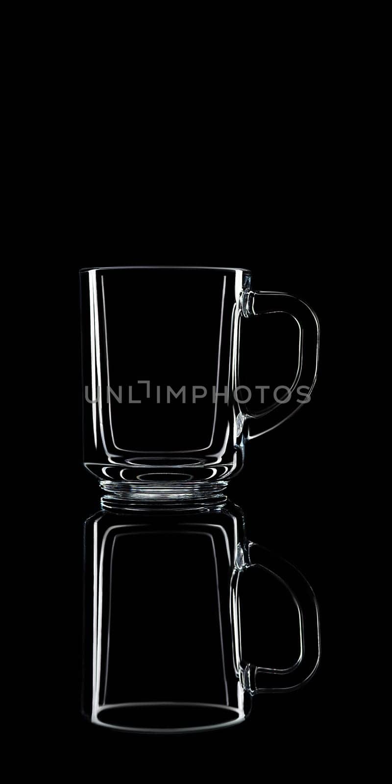 Just a glass on a black background with a reflection. Isolated.